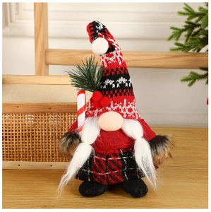 Detail of Christmas gnome with knit hat and candy cane accessory on wooden table