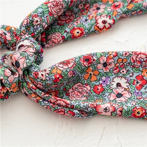 Macro detail of blue floral scrunchie texture and knotted fabric with artistic prints