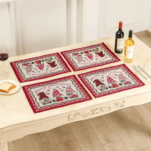 Set of 4 Christmas gnome placemats with Merry Christmas text on marble table