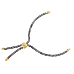 Macro detail of adjustable woven bracelet with gold Tree of Life metal slider bead