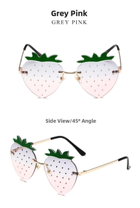 Detail view of strawberry-shaped rimless sunglasses with grey and pink gradient lenses