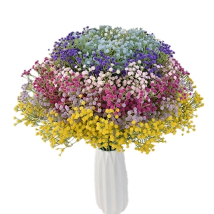 Colorful artificial gypsophila bouquet in white geometric vase for home decor