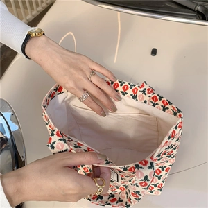 Detailed view of the corduroy tote bag interior featuring tulip print and inner pocket