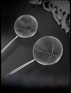 Detail of stainless steel spiral skimmer with reinforced wire and long handle
