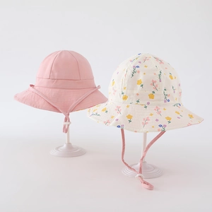 Detail view of pink and floral cotton sun hats with adjustable windproof chin straps