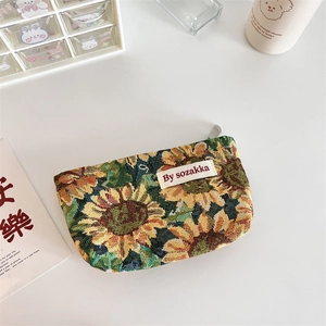 Detail of sunflower jacquard woven pouch with metal zipper and minimalist logo label