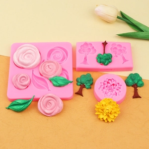Detailed pink silicone molds for creating realistic fondant roses and green tree leaves