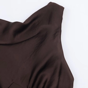 Detailed view of dark brown satin dress neckline with smooth silk texture and drape