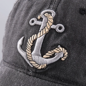 Faded black cotton baseball cap with detailed white anchor embroidery on the front
