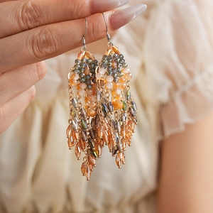 Vintage bohemian tassel hook earrings with orange and teal beads on golden chains