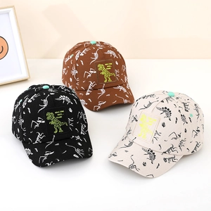 Three children's baseball caps featuring dinosaur skeleton prints and embroidered patches