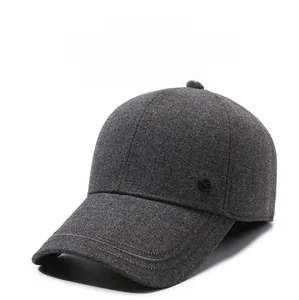 Detailed close-up of thick dark grey wool baseball cap showing fine stitching and texture