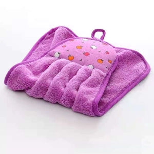 Close-up of purple coral fleece hand towel with apple embroidery and hanging loop