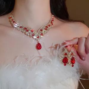 Elegant vintage jewelry set with red teardrop gems and rhinestones on a model