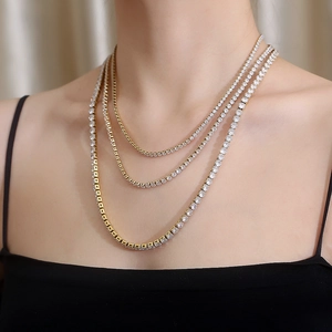 Close-up of triple-layered gold and silver tennis chains with sparkling zircons