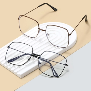 Stylish square metal frame glasses in black and bronze colors on a geometric platform