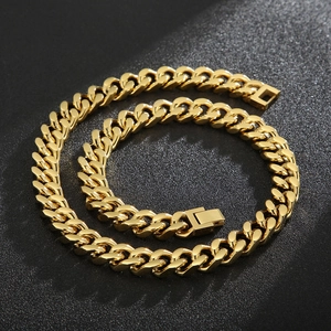 Detail of golden Cuban link chain with flat ring structure and fold-over clasp on black base