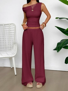 Burgundy sleeveless top and wide-leg trousers set displayed in an indoor setting