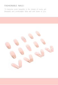 Detailed view of coffin-shaped nude pink press-on nails with 3D white flowers and pearls