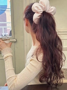 Elegant satin champagne oversized hair scrunchie shown on a ponytail in natural light