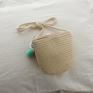 Cute mini woven straw crossbody bag for kids with colorful pom-pom decor and rope strap
