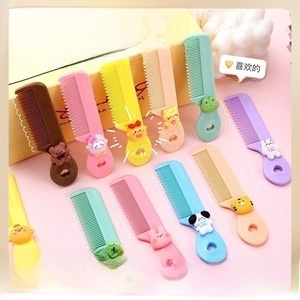Macro shot of colorful cartoon combs with rounded teeth and animal handles for kids