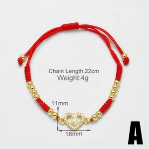 Macro view of 18k gold plated heart Virgin Mary pendant on adjustable red woven cord