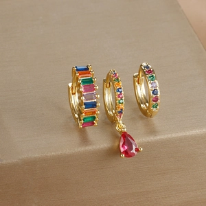Detail of 3-piece gold-plated earring set featuring rainbow crystals and red teardrop gems