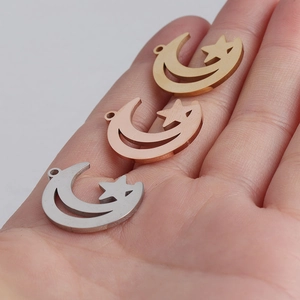 Detailed view of hollow star and moon charms in gold, silver, and rose gold on a palm