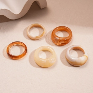 Close-up of vintage resin acrylic rings with marble texture and amber tones