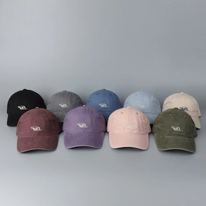 Detail view of washed cotton baseball caps in nine colors with embroidered logo