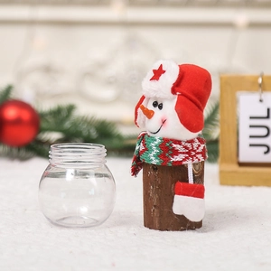 Christmas snowman candy jar decoration with striped scarf and star hat on wooden base