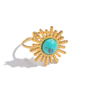 Detailed macro view of vintage gold sunburst ring with central turquoise and braided band