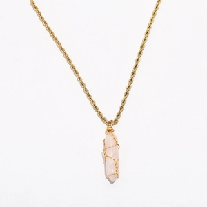 Close-up of pink hexagonal crystal pendant with golden twisted rope chain detail