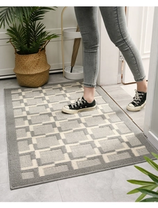 Detail showing Nordic gray and white geometric checkered doormat with non-slip texture