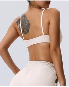 Detail of ribbed beige sports bra and high-waist leggings showing seamless texture and fit