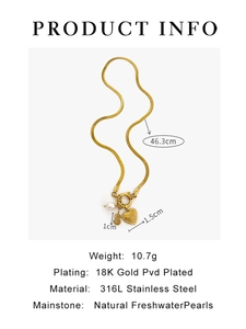 Macro detail of 18K gold plated snake chain necklace with pearl and initial S charm