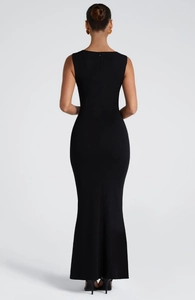 Back view of a sleek black sleeveless maxi dress with invisible zipper and fish tail hem