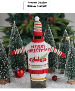 Detail of Christmas wine bottle cover with knit sweater, mini hat, and festive truck motif