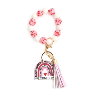 Detail of beaded Valentine's Day keychain with pink heart beads and a colorful tassel