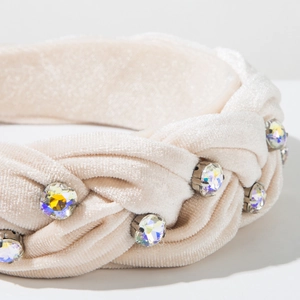 Close-up detail of champagne velvet braided headband with sparkling rhinestone inlay