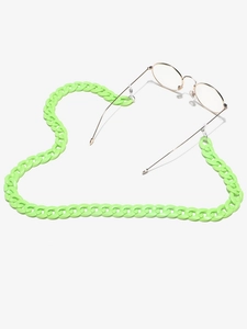 Neon green acrylic glasses chain styled in a heart shape on a clean white background