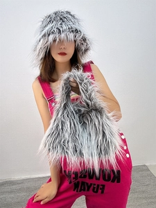 Detail of high-quality faux fur bucket hat and matching handbag in mixed grey tones