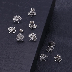 Minimalist Tree of Life stud earrings in polished stainless steel set on black background