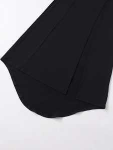 Detailed close-up of the black crepe maxi dress featuring a curved hem and side slit detail