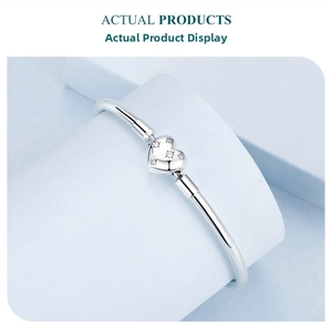 Macro shot of S925 sterling silver heart bangle with zircon star engraving detail