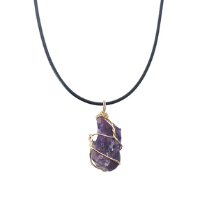 Irregular raw amethyst stone pendant with golden wire wrap on black cord necklace