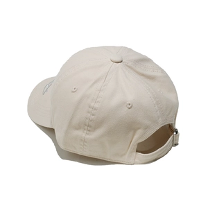 Detail of beige cotton baseball cap featuring silver side embroidery and metal buckle