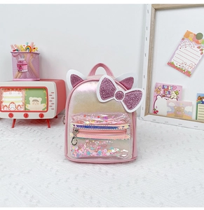 Close-up of pink laser PU backpack with glittery cat ears and colorful sequin front pocket