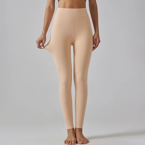 Close-up of high elasticity stretch on nude fleece-lined leggings for winter warmth